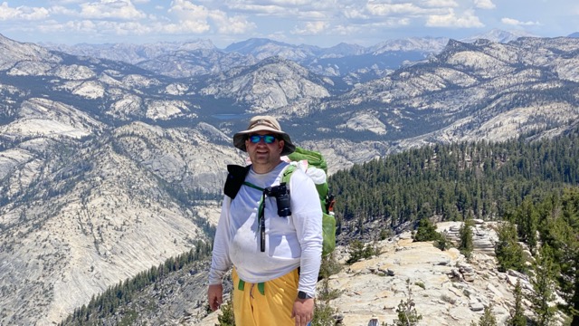 Looking from Clouds Rest to Tenaya Lake. With David Rogers climbing the ridge.