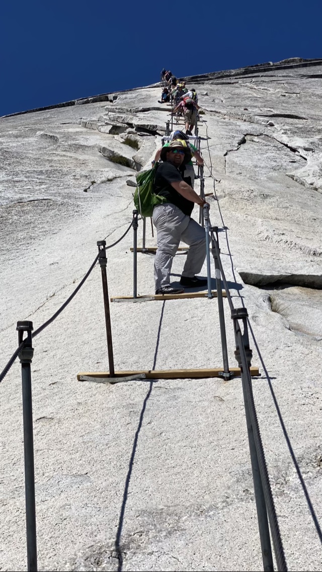 Looking up the cables towards the top of Half Dome. David climbing up.